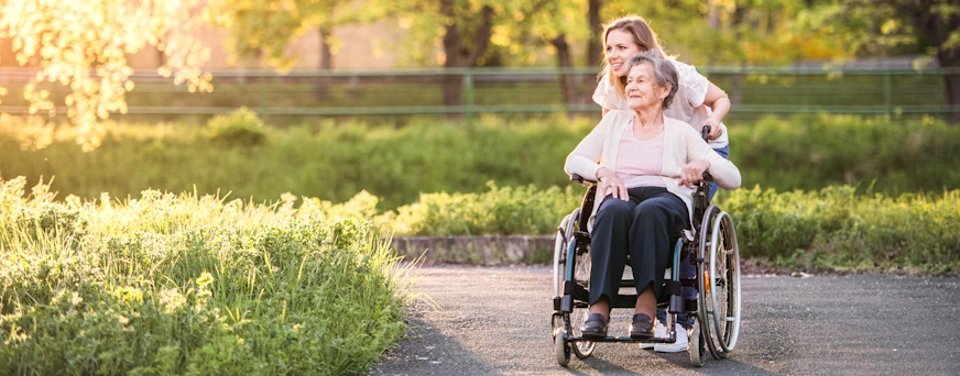 blog/Life Assure Elderly Grandmother In Wheelchair With Grandaughter In Spring Nature Hero